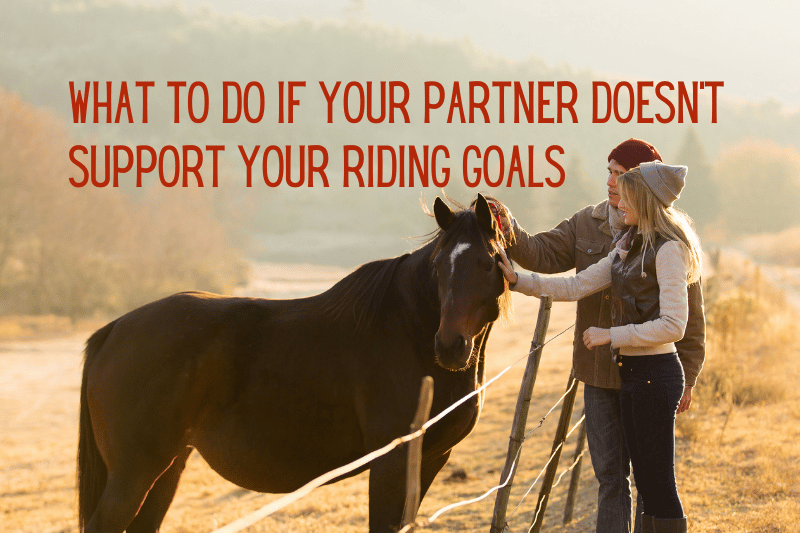 couple petting horse across fence
